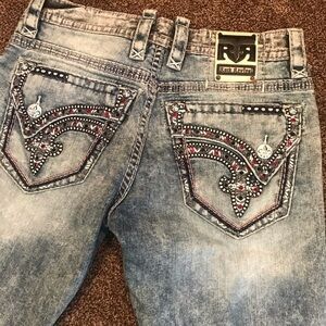 Rock Revival Men's Distressed Blue Jeans with Embellished Pockets